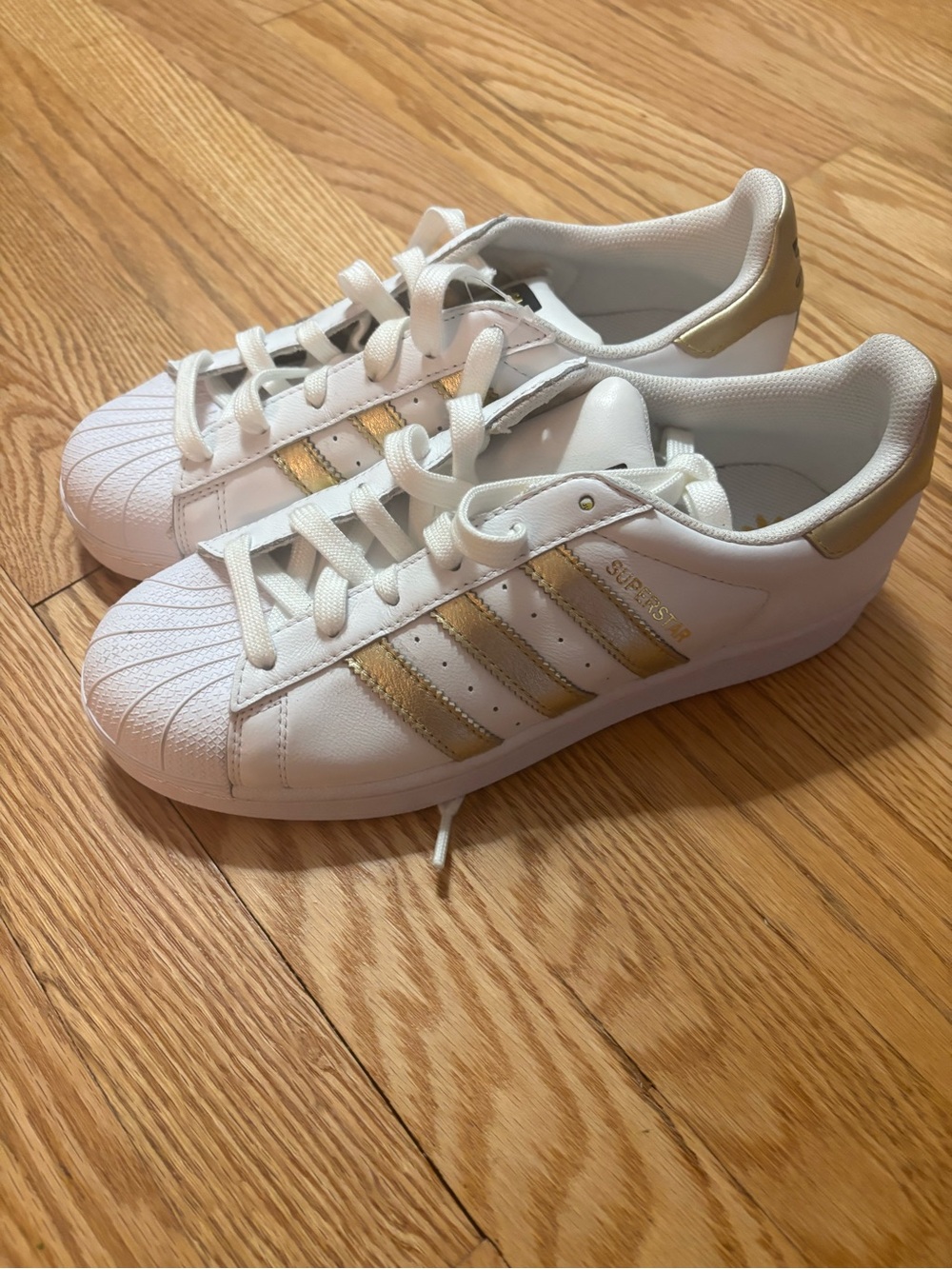 adidas Women's White Sneakers with Gold Stripe Accents